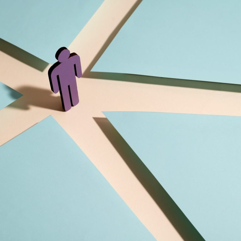 Eine lila Figur steht an einer Kreuzung und kann sich entscheiden verschiedene Wege zu gehen